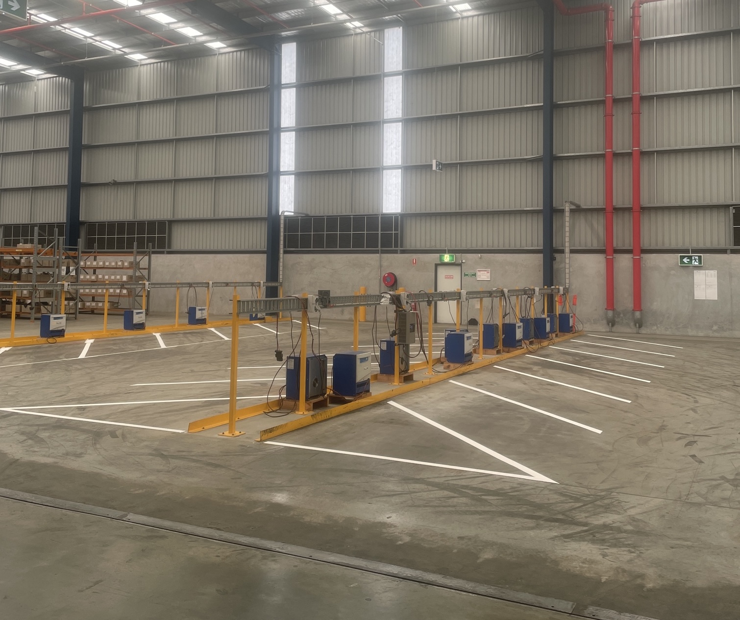 White industrial parking bay line marking around charging equipment