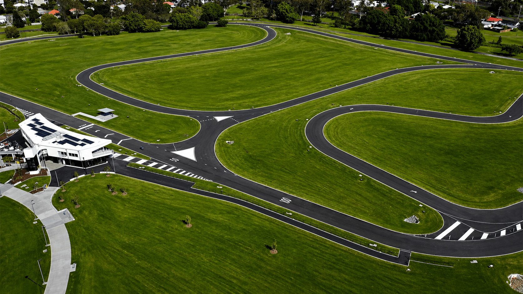 Sweeping aerial view of a marked driver training facility