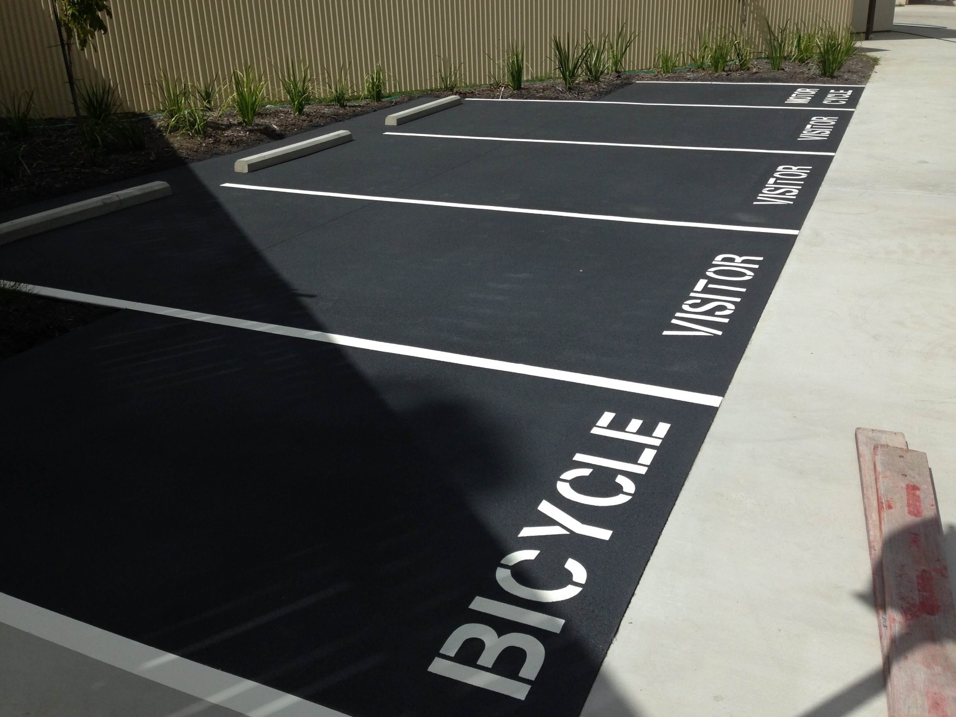 Residential car park with visitor, bicycle and motorcycle stencilled bays
