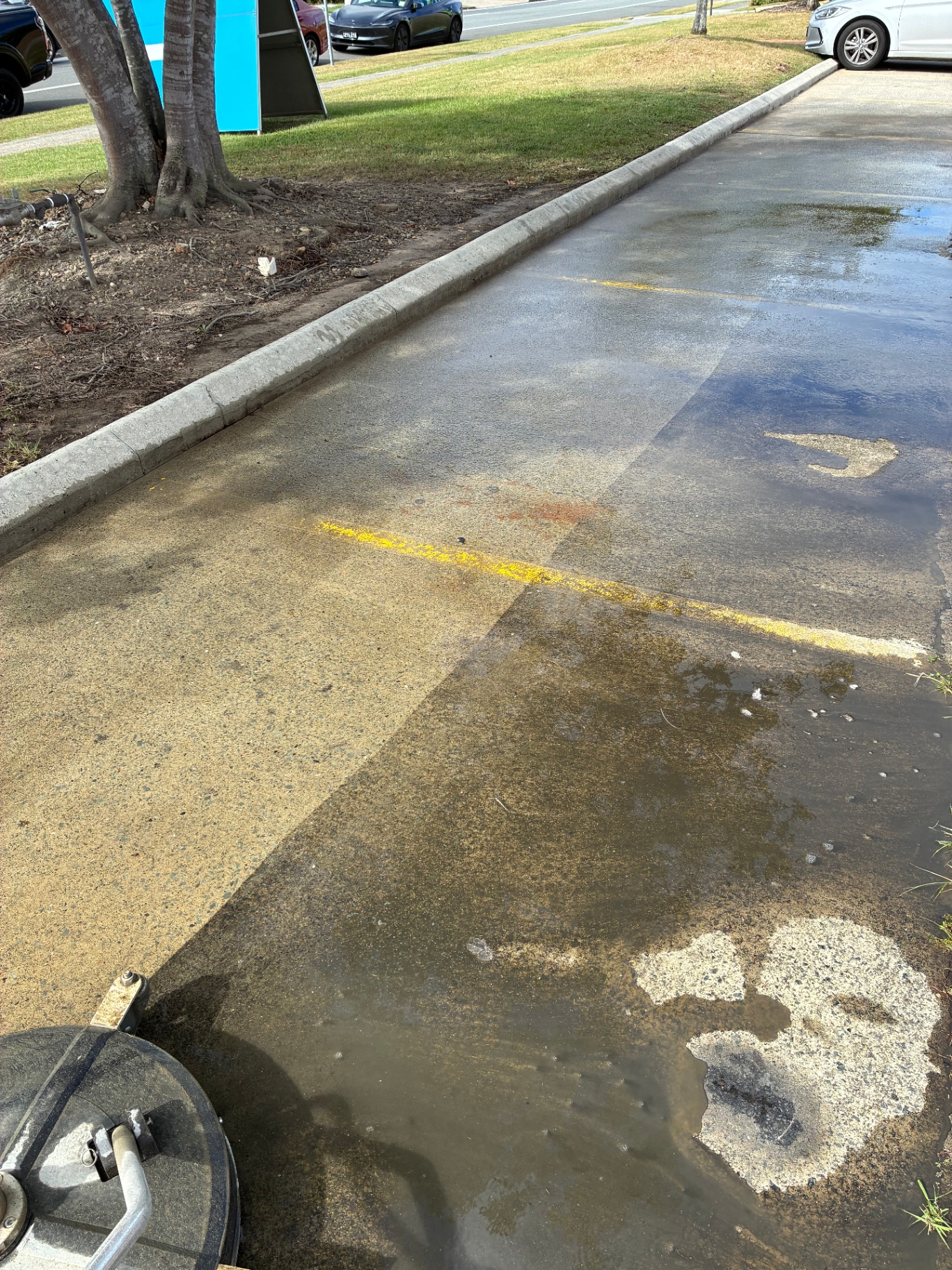Before and after pressure cleaning result on a commercial driveway
