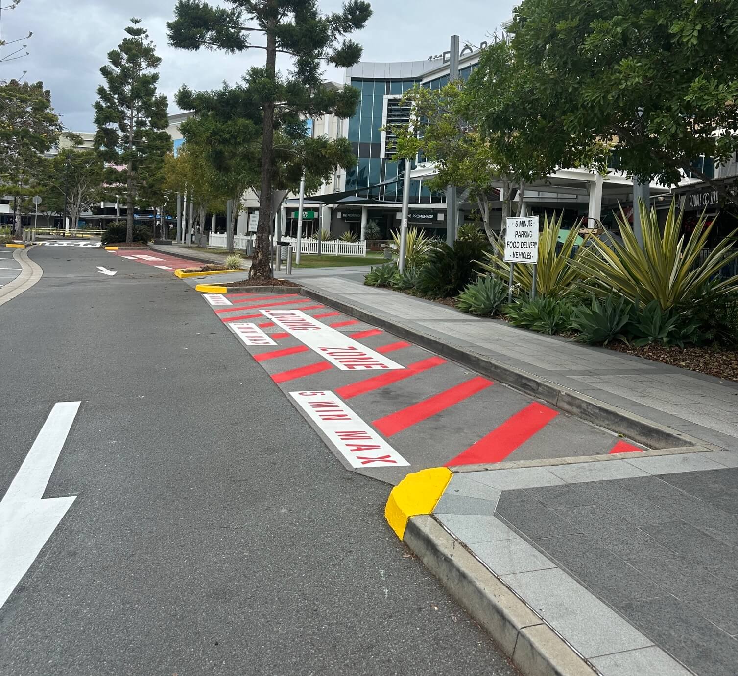 Commercial red loading zone with 5 minute max line marking and painted kerb
