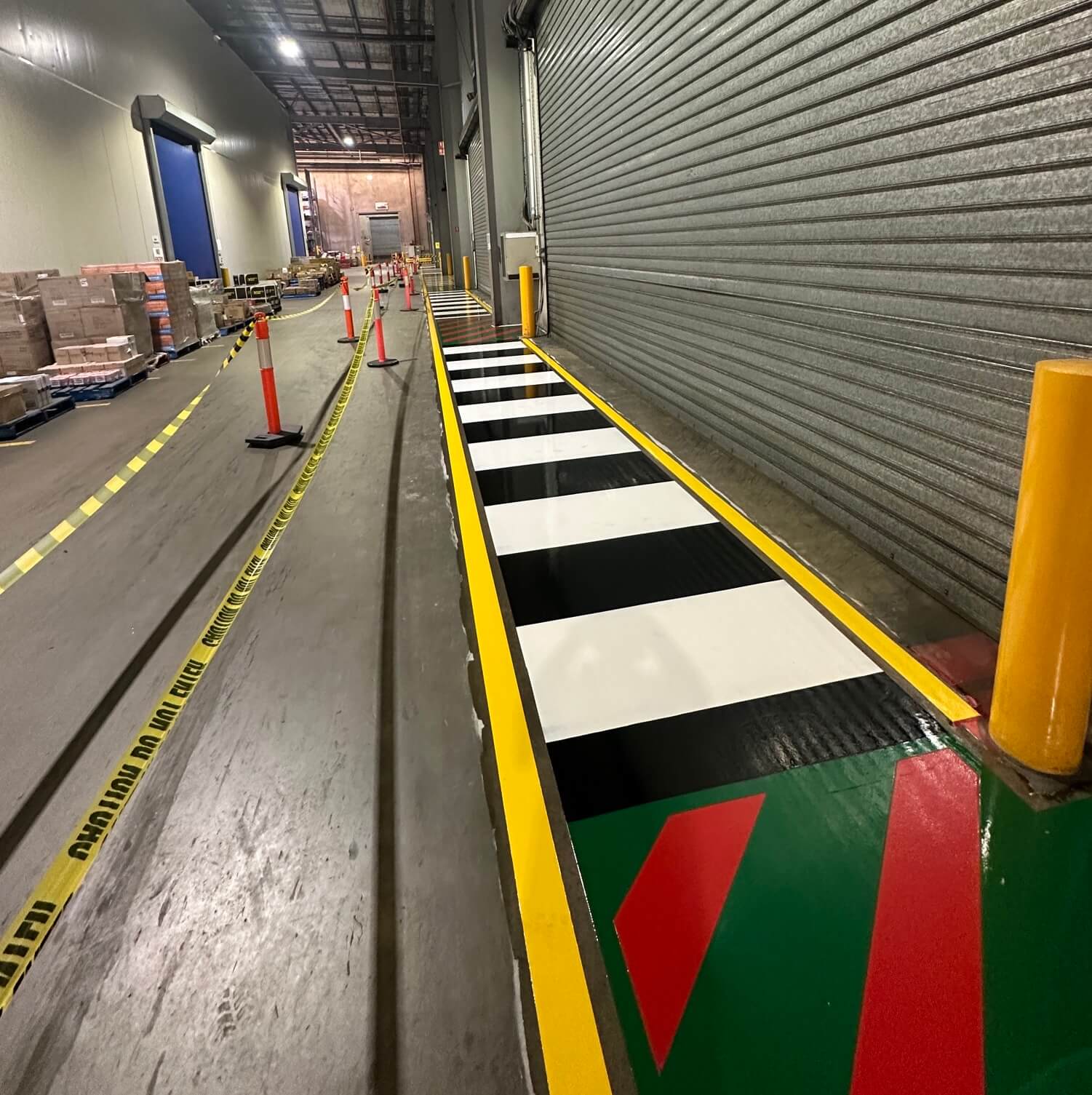 Warehouse industrial floor with fresh yellow line marking between racking
