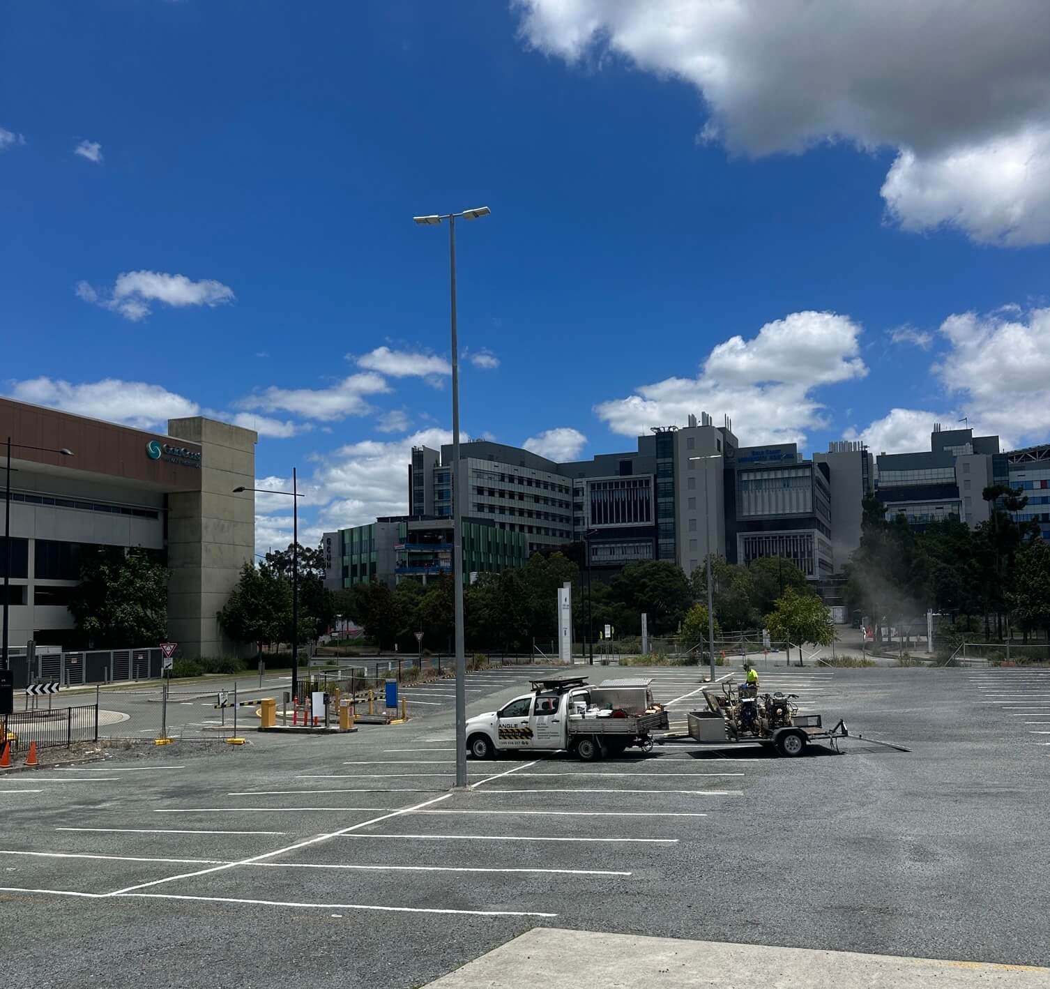 Hospital car park with fresh white bay line marking and Angle Line Marking spray truck