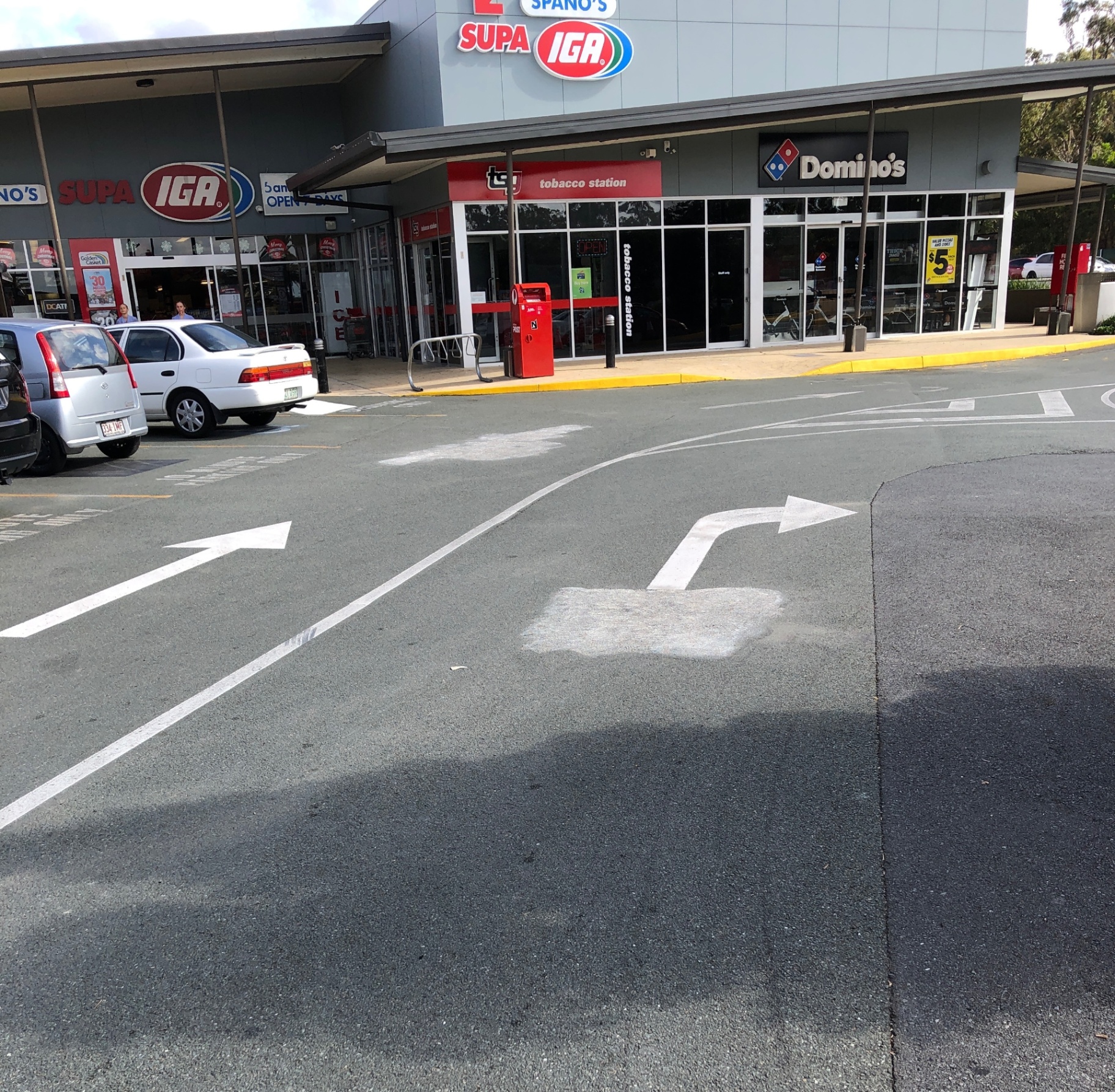 Retail centre driveway with removed directional markings ready for repainting