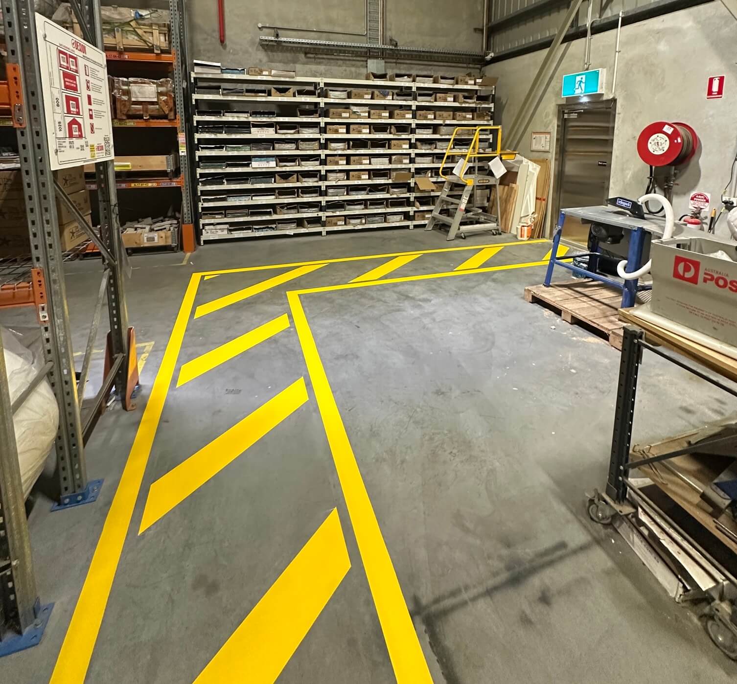 Warehouse aisle with yellow chevron hazard safety line marking