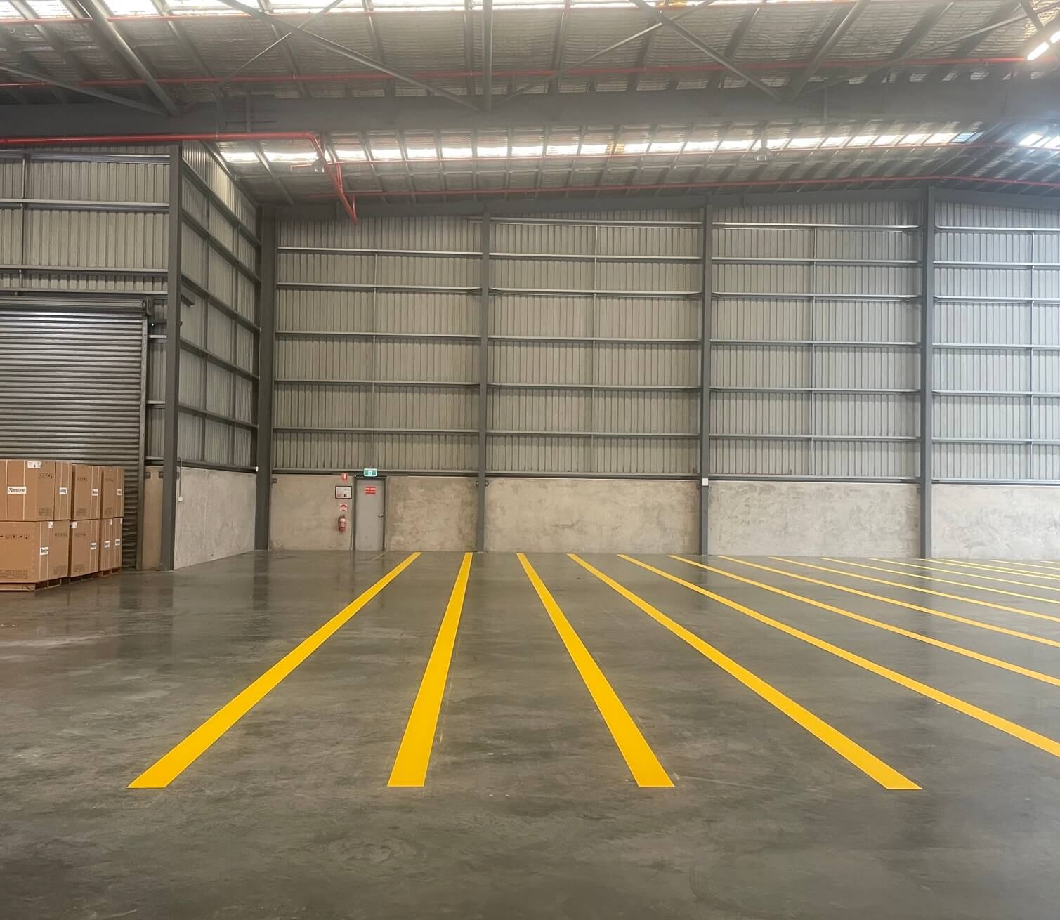 Warehouse concrete floor with fresh yellow line marking