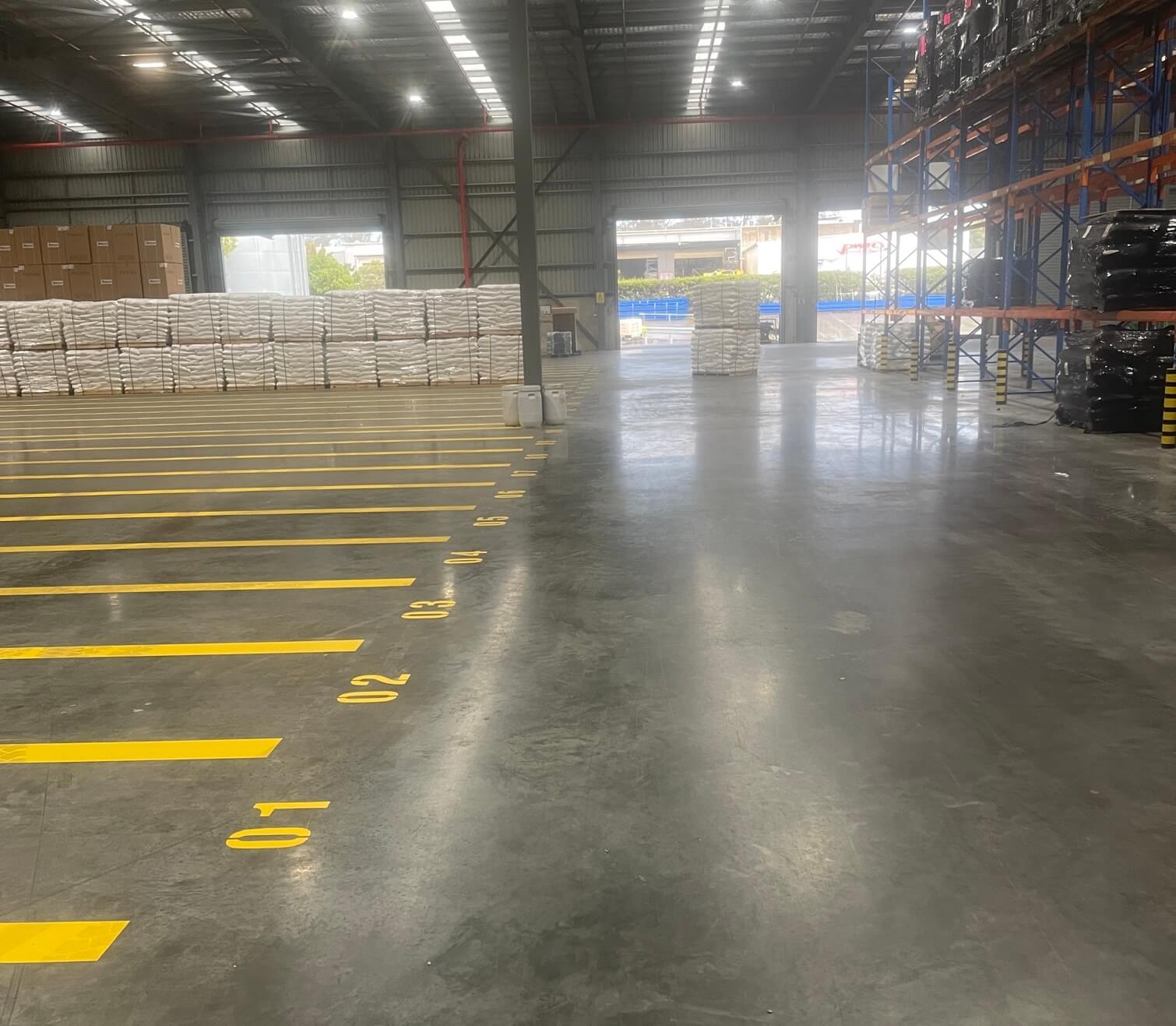 Warehouse floor with numbered yellow pallet bay line marking