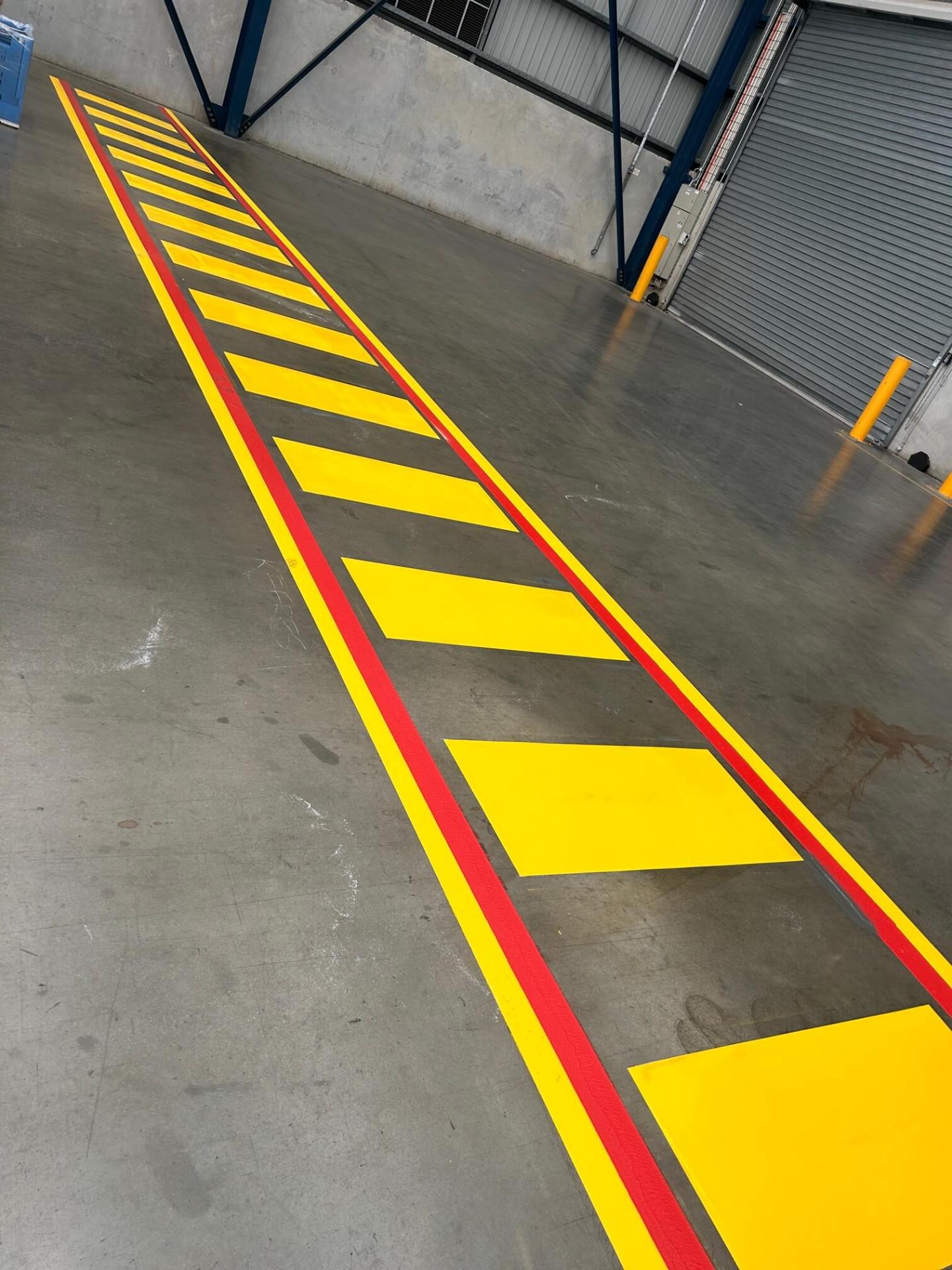 Warehouse red and yellow hatched exclusion zone line marking