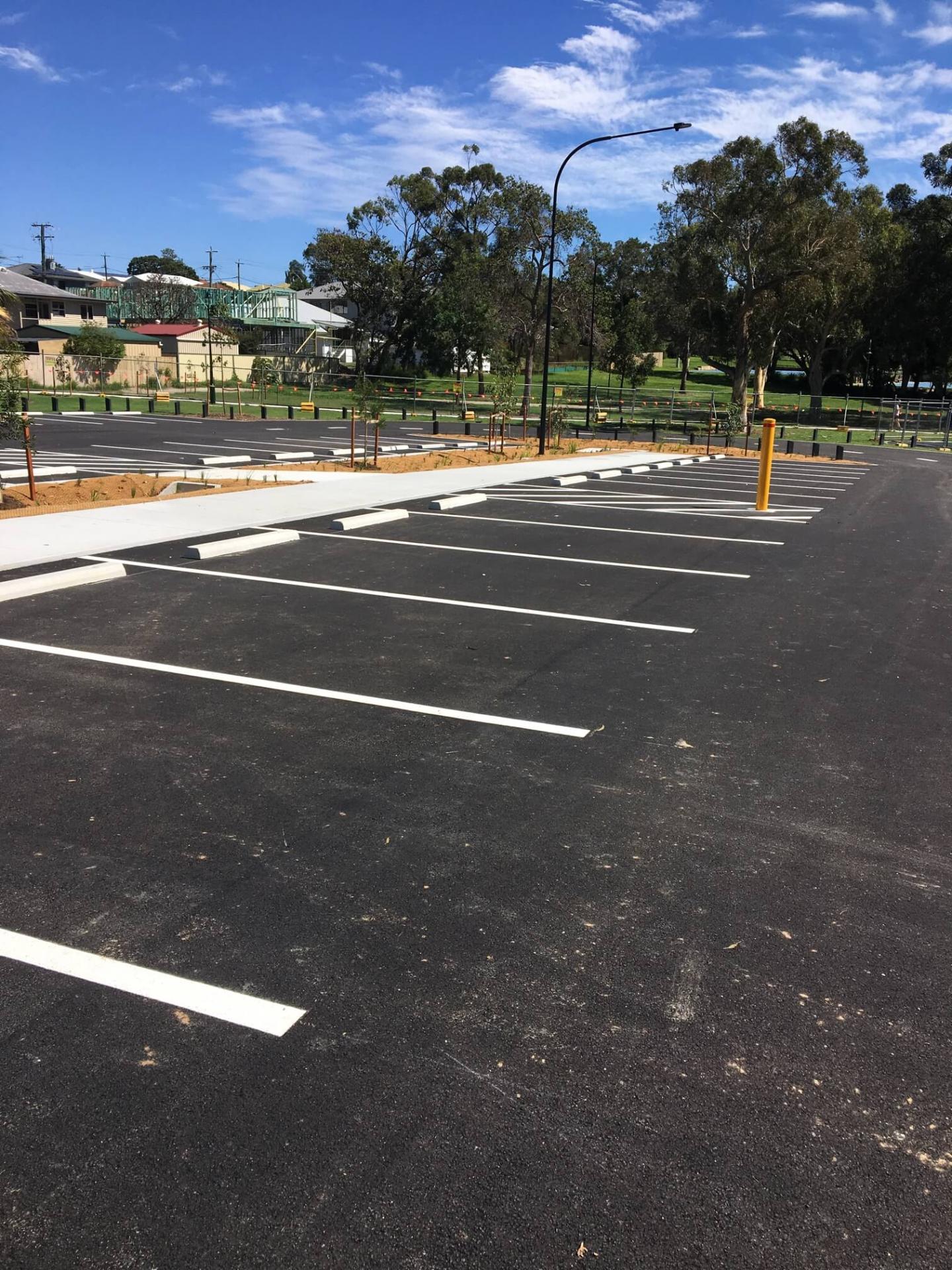 Commercial car park with white line marked bays and wheel stops
