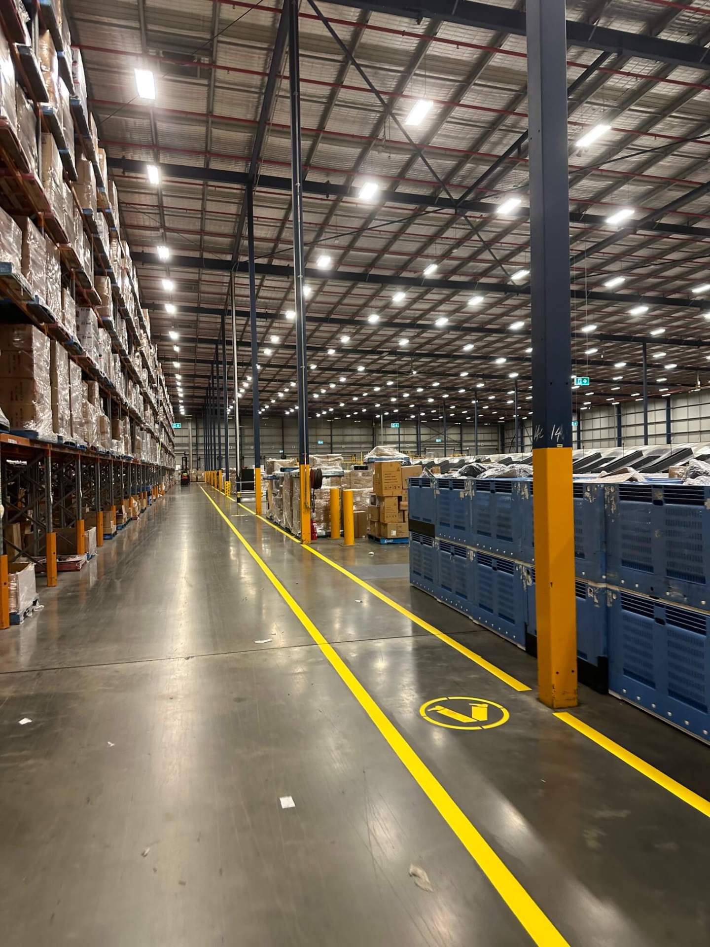 Warehouse yellow forklift travel lane with pedestrian safety symbol