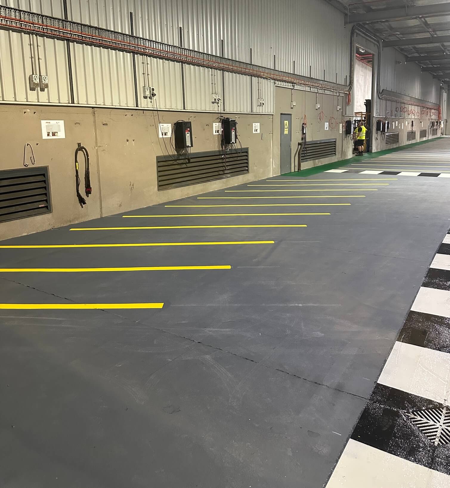 Warehouse yellow parking bays alongside a black and white pedestrian crossing