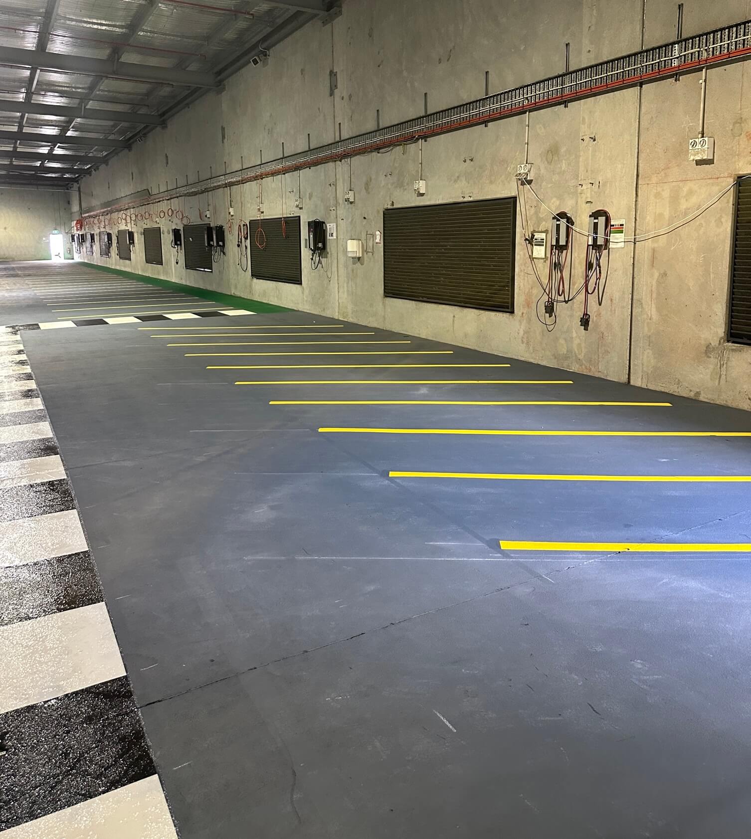 Warehouse yellow parking bays with black and white checkered pedestrian crossing