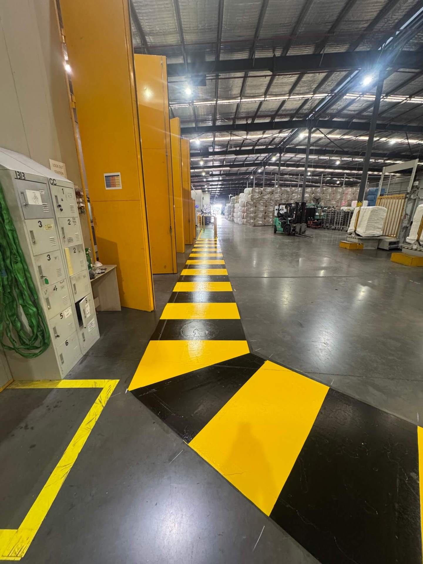 Warehouse yellow and black hazard striped walkway line marking