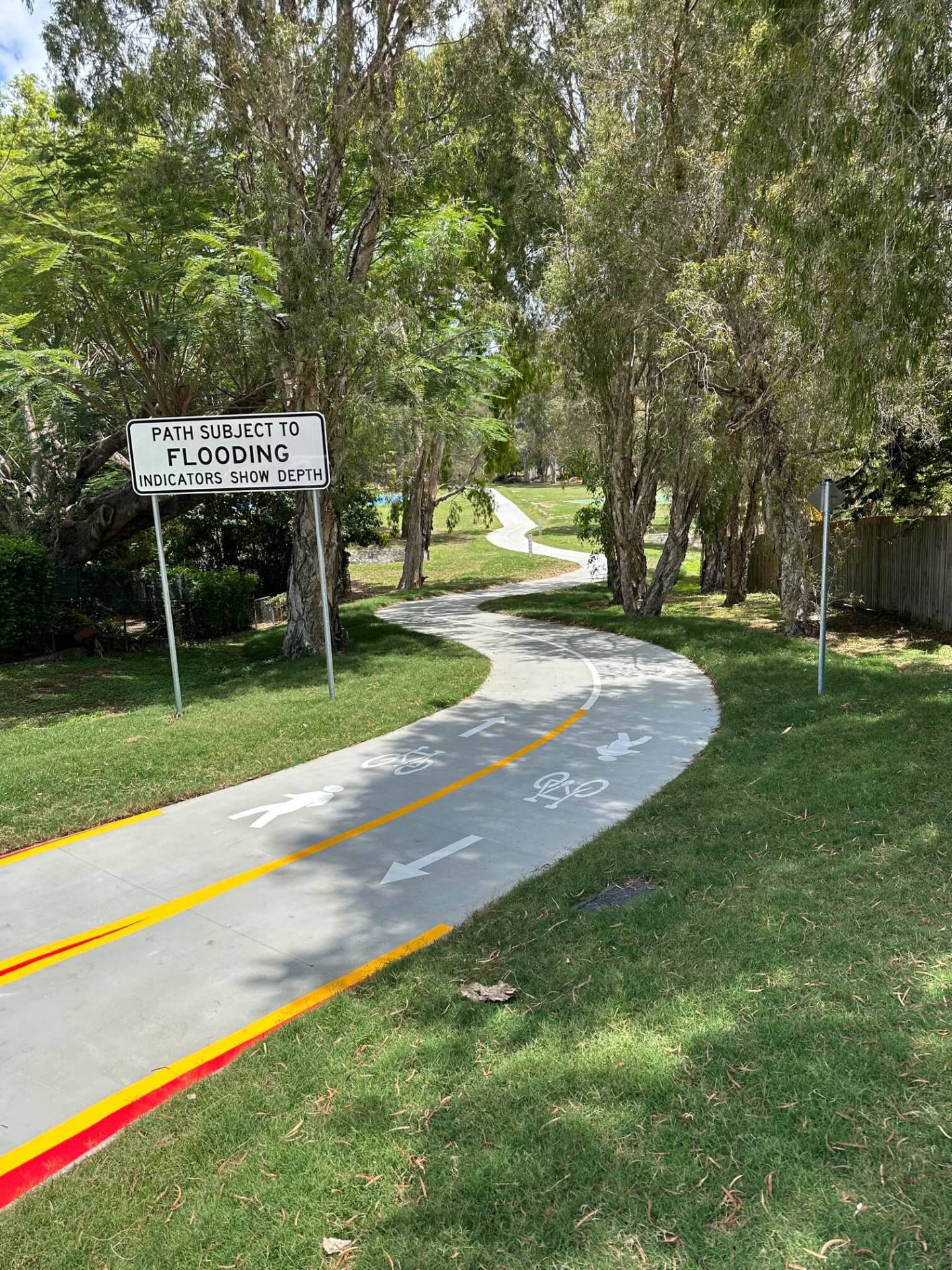 Brisbane shared path with bike and pedestrian lane marking and flood indicators