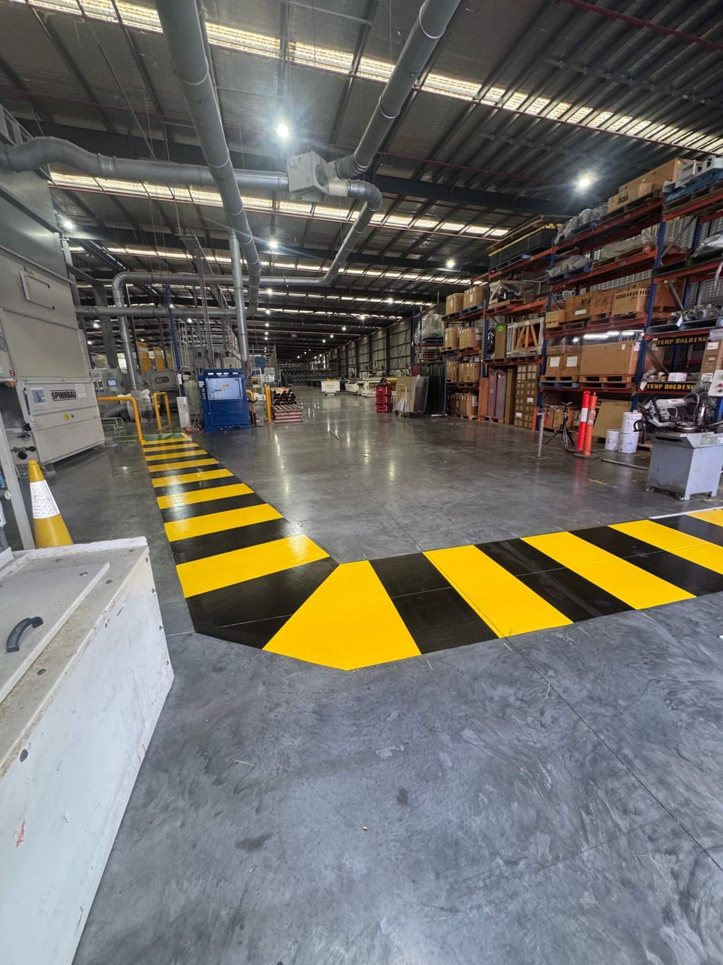 Warehouse yellow and black chevron hazard line marking for forklift zone