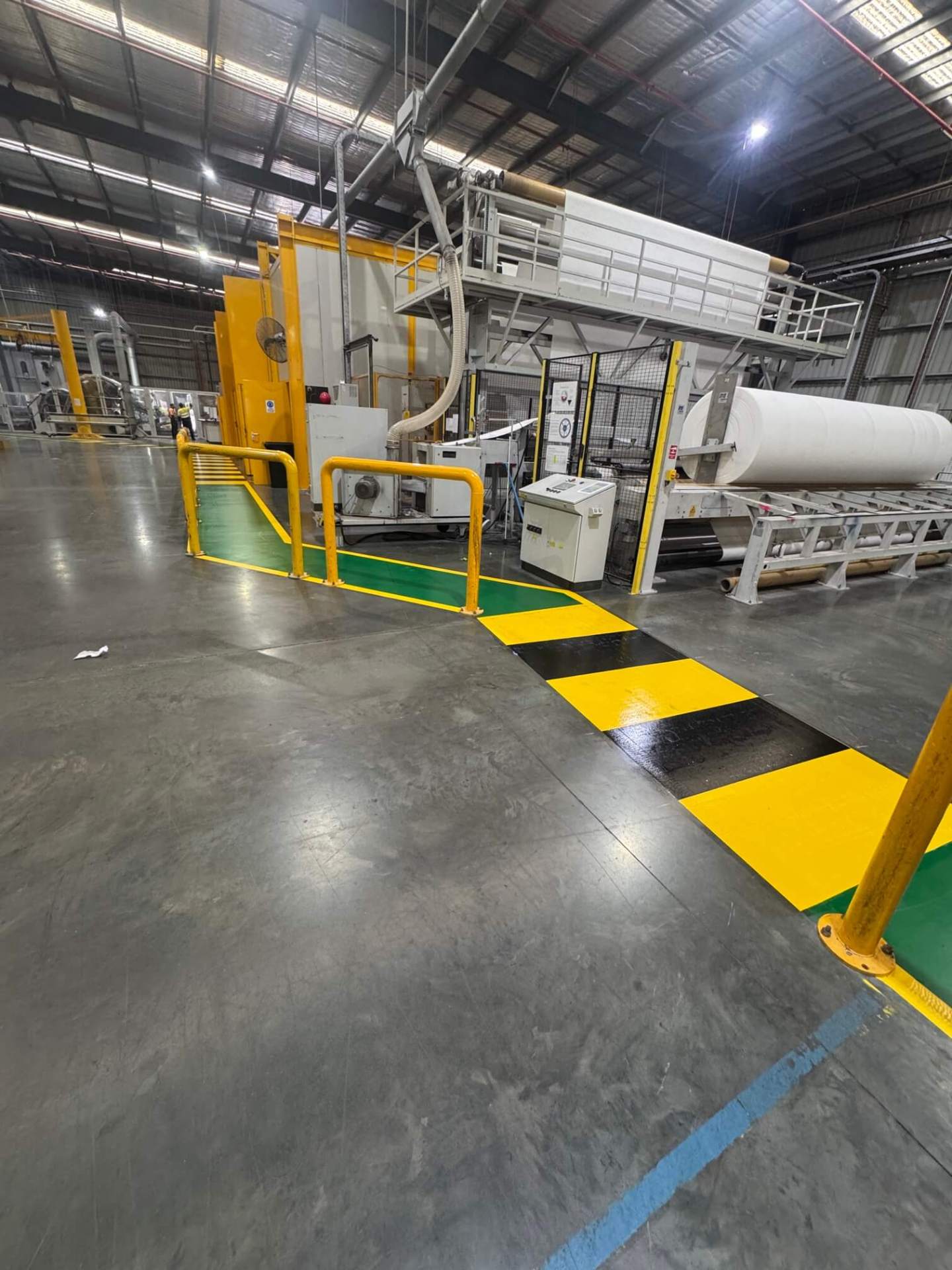 Factory yellow and black safety crossing beside industrial machinery