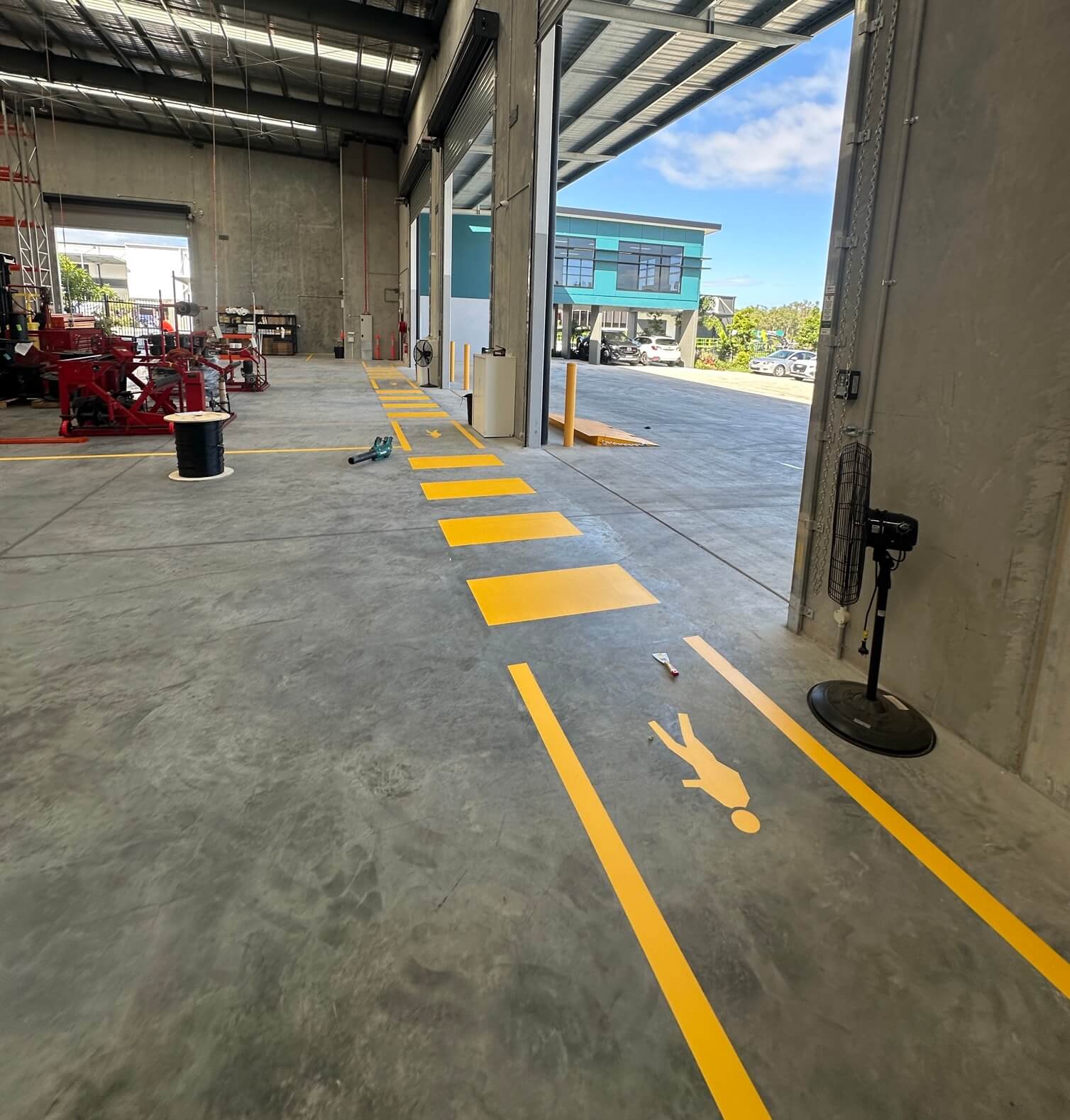 Warehouse yellow pedestrian walkway line marking with stencilled safety figure