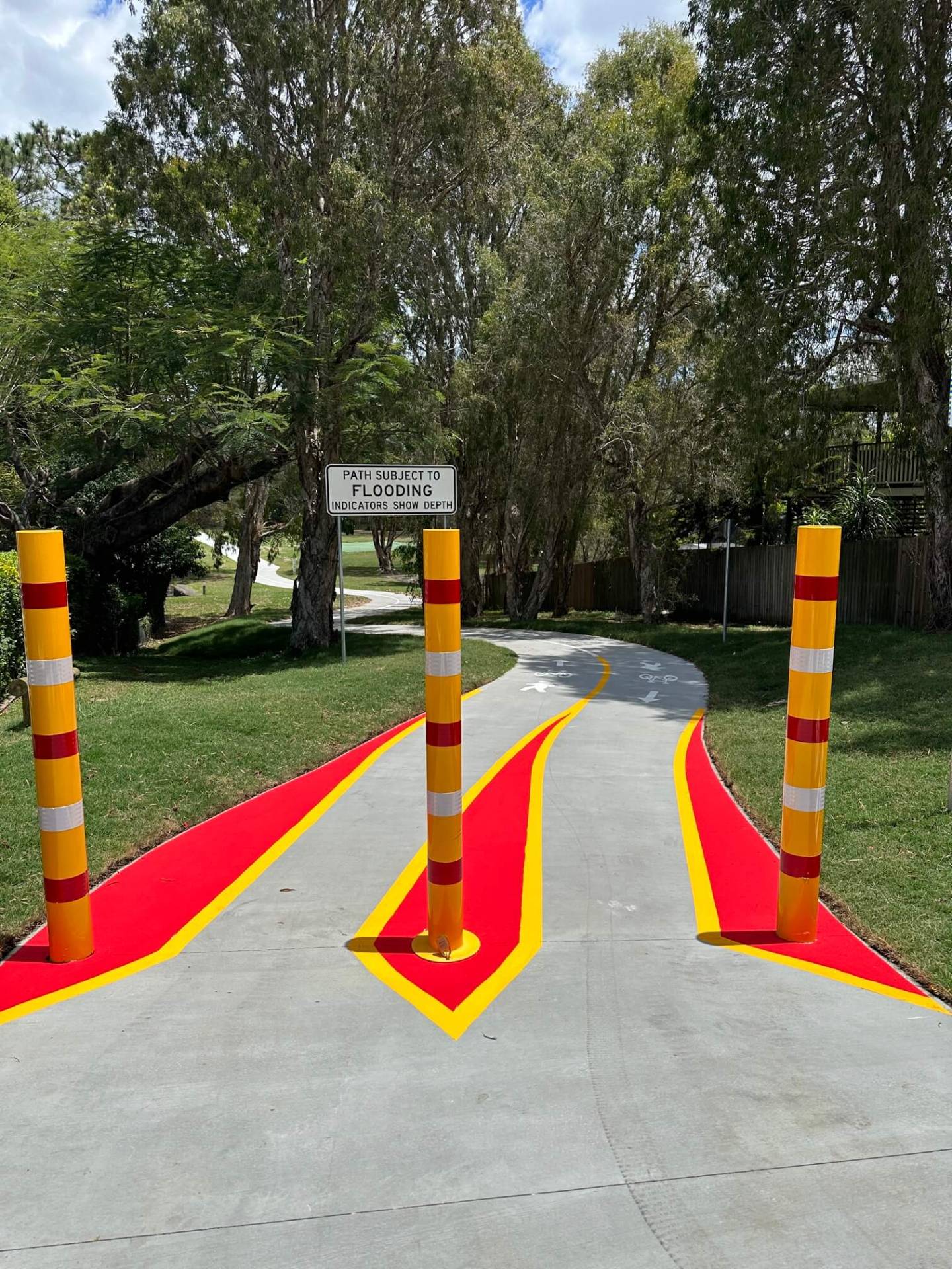Brisbane bikeway with red and yellow flood bollard safety line marking