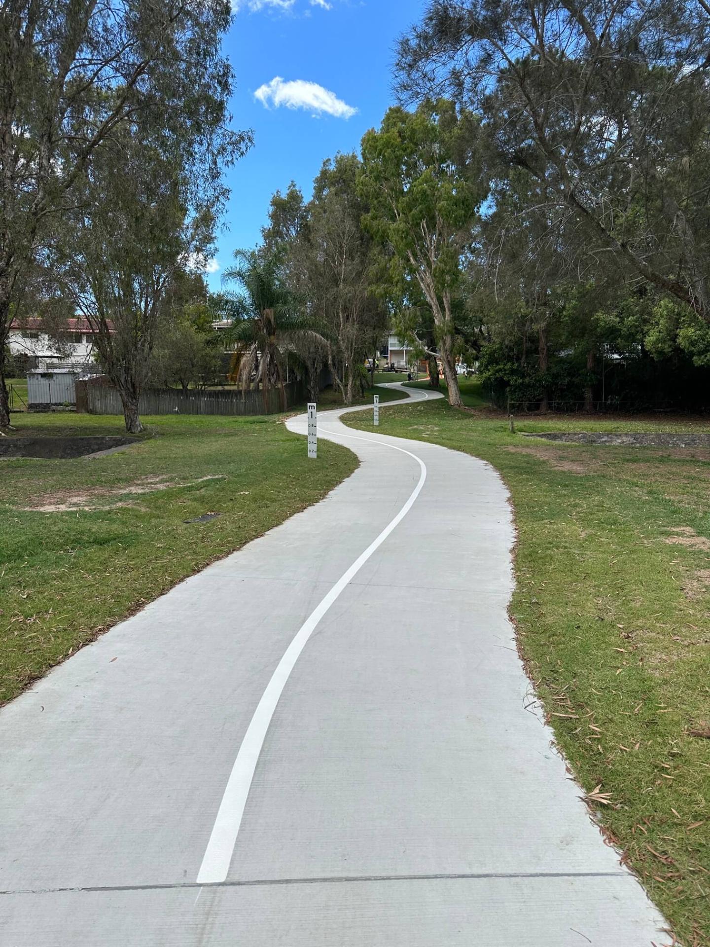 Brisbane residential shared path through parkland with white edge line marking