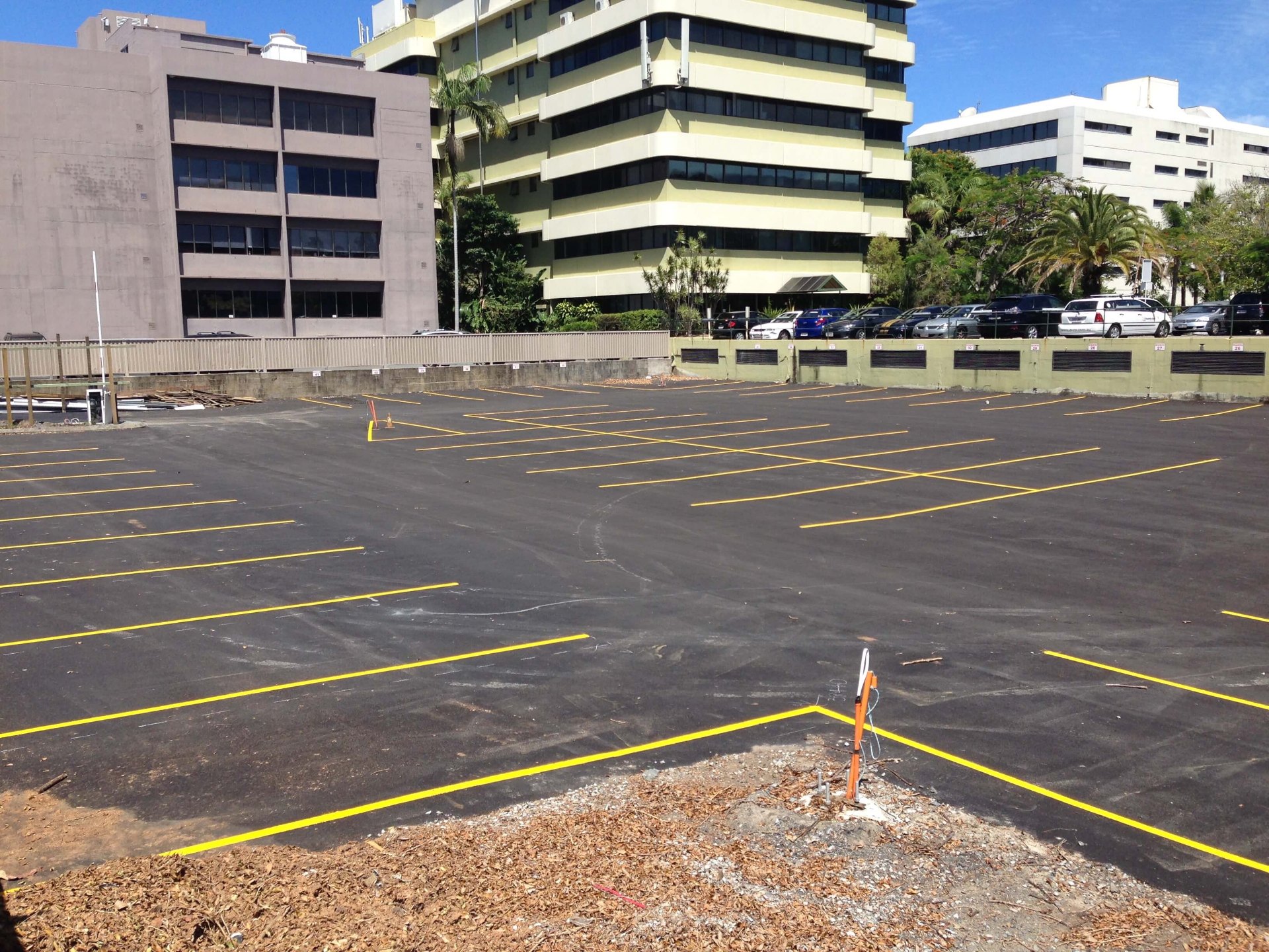 Commercial asphalt car park with fresh yellow line marked bays