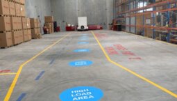 line markings on a factory floor, clearly designating safe walkways, hazard zones, and equipment areas for enhanced safety and organisation.